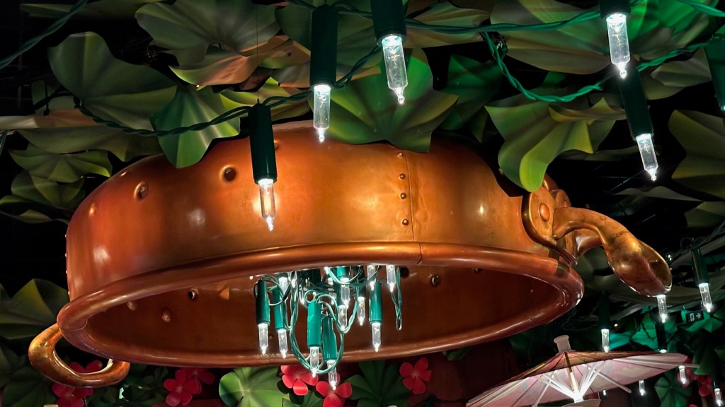 Giant light bulb fixtures among leaves in the ceiling of Bistrot Chez Remy at Disneyland Paris