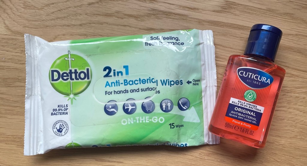 Packet of anti-bacterial wipes and a bottle of hand sanitizer