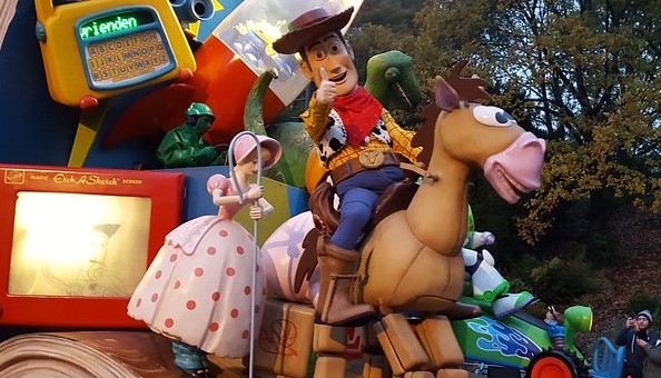 Woody from Toy Story sitting on a model of Bullseye