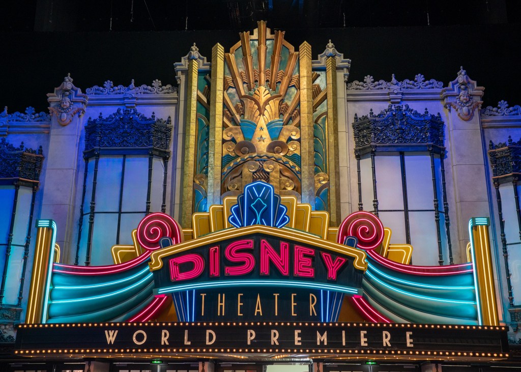 Sign saying 'Disney theater world premiere' with neon lights inside new World Premiere at Disneyland Paris