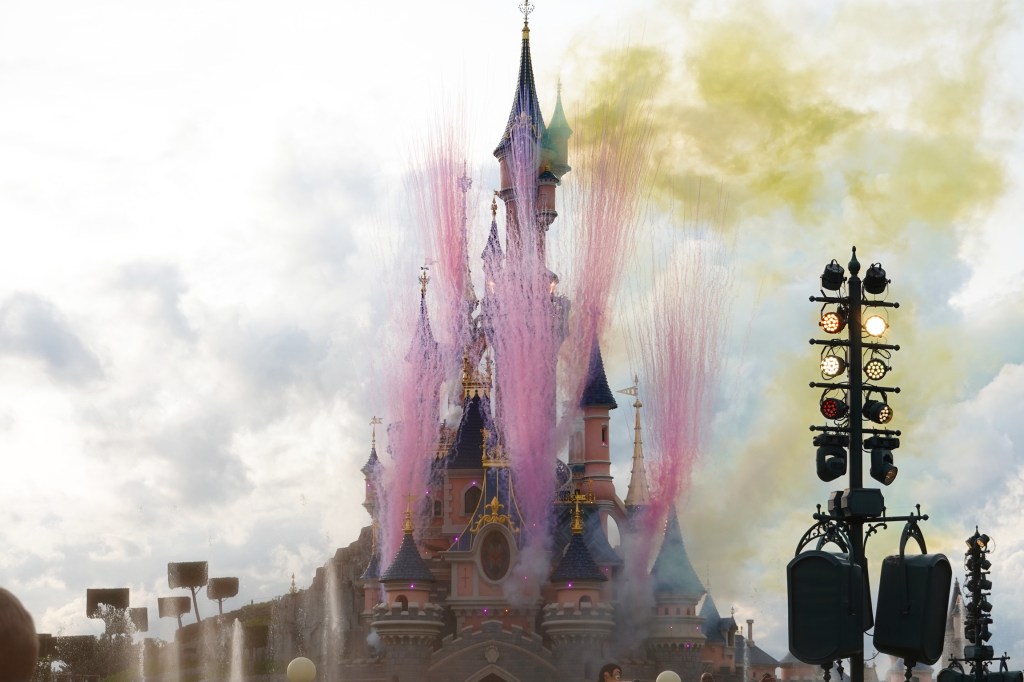 Castle with coloured smoke at Disneyland Paris