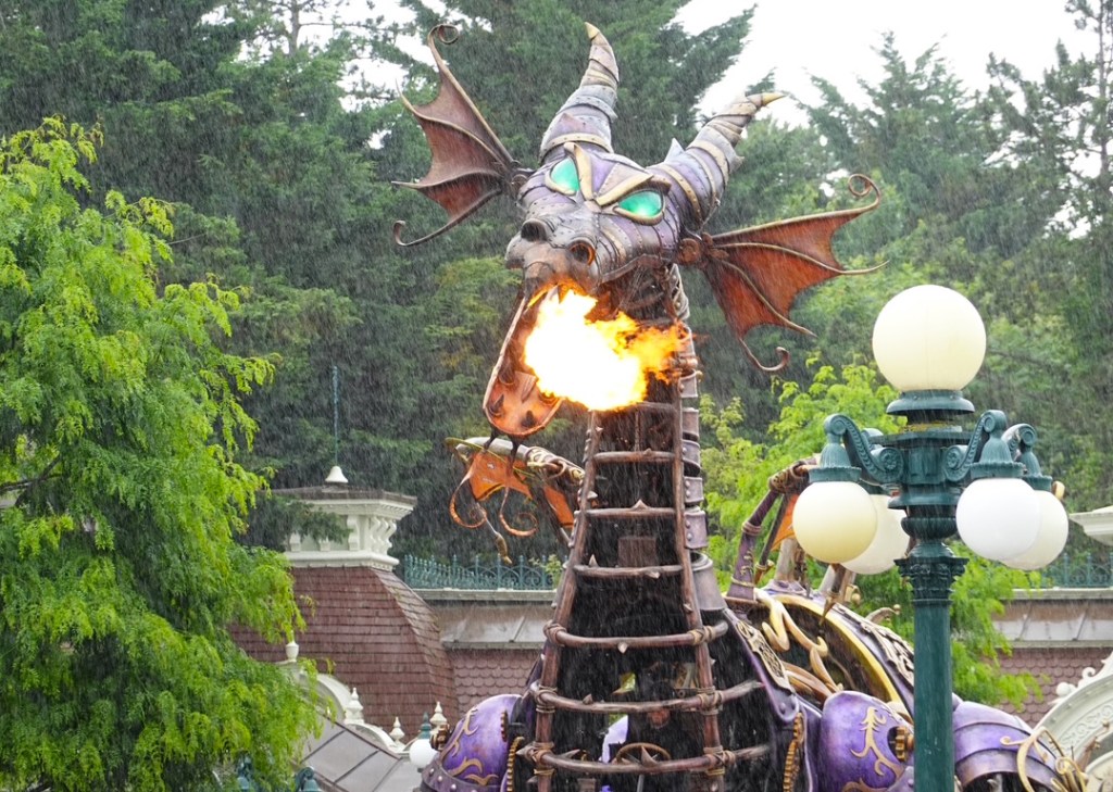 Maleficent dragon breathing fire in the rain