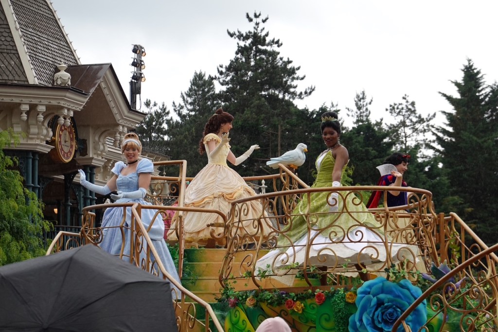 Cinderella, Belle, Tiana and Snow White on a parade float at Disneyland Paris