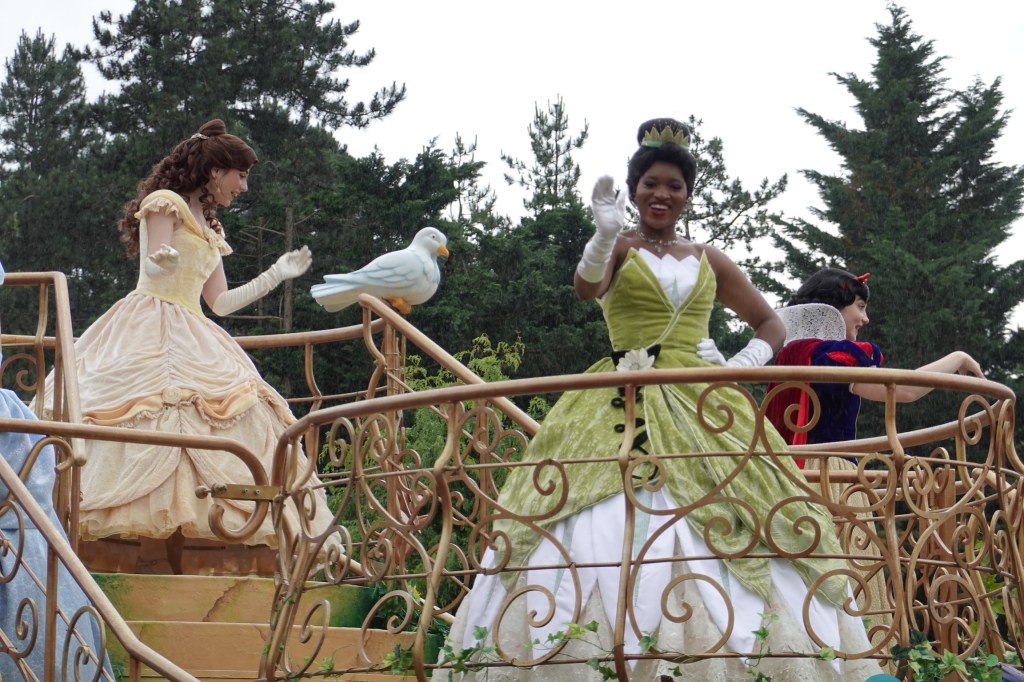 Princess Tiana and Belle on a parade float in Disneyland Paris
