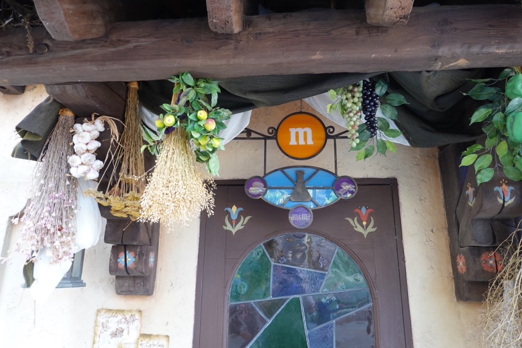Door with M&M symbol hanging above it