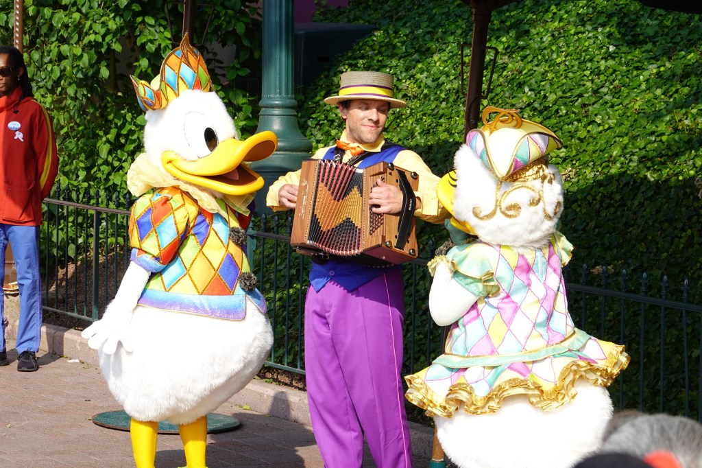 Donald and Daisy Duck with an accordionist