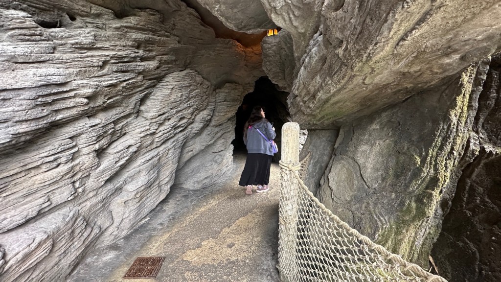 Woman walking into Cave on Adventure Isle