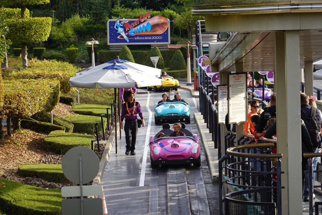 Cars and cast members at the Autopia ride in Disneyland Paris