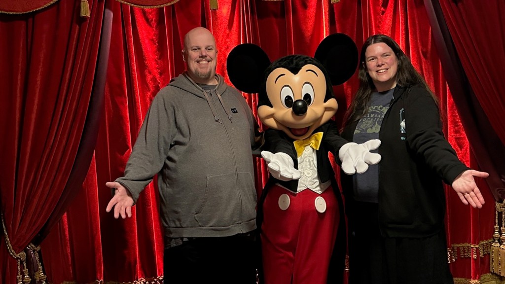 Man and woman with Mickey Mouse in Disneyland Paris
