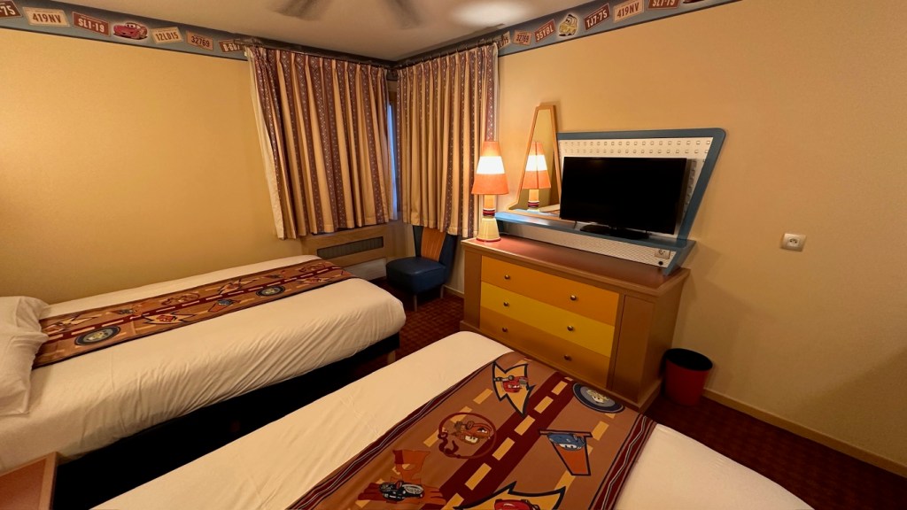 Bed, TV and storage in a room at Hotel Santa Fe in Disneyland Paris