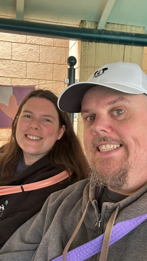 Man and woman smiling on It's a Small World in Disneyland Paris