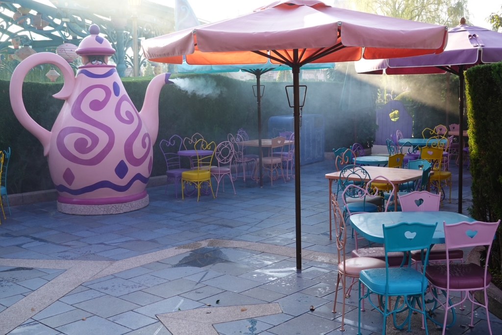 Seating area themed to Alice in Wonderland in Disneyland Paris, with a dormouse figure peeking out of teapot